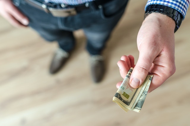 person handing over money